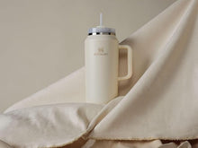 Load image into Gallery viewer, Stanley Quencher H2.0 FlowState Stainless Steel Vacuum Insulated Tumbler with Lid and Straw for Water, Iced Tea or Coffee, Smoothie and More, Cream 2.0, 64oz